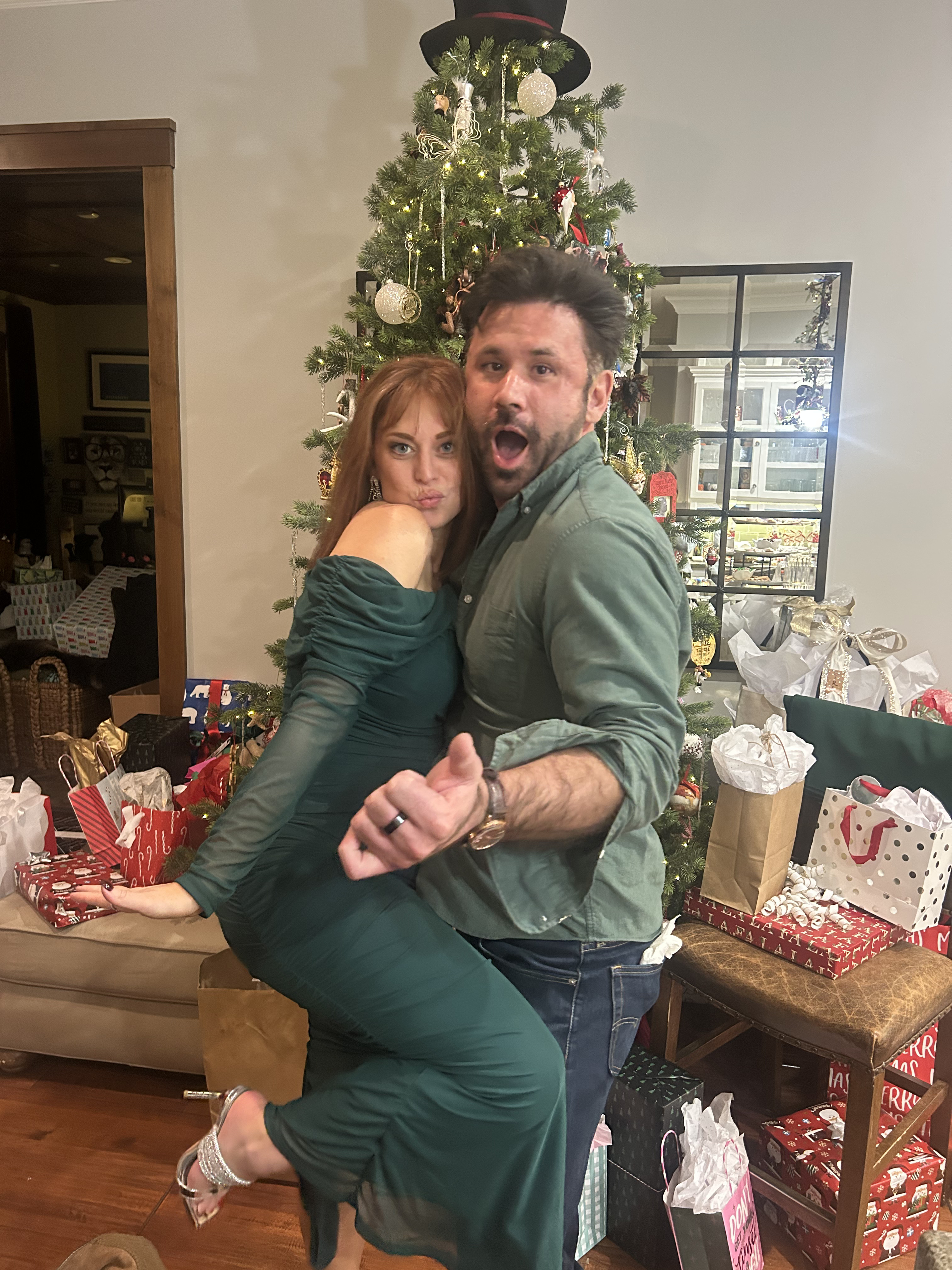 Adam lifting Ashlee by the tree